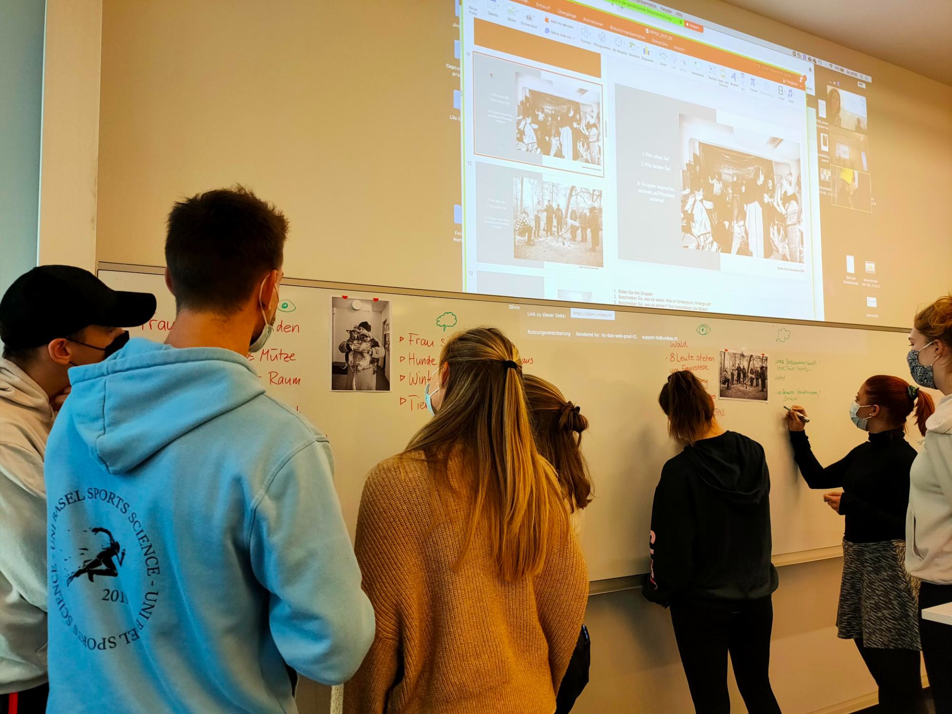 Studenten beim Notieren wichtiger Punkte zu den Bildern